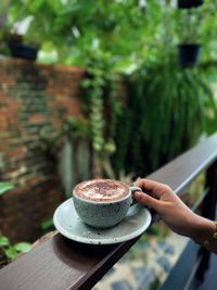 Person holding coffee cup