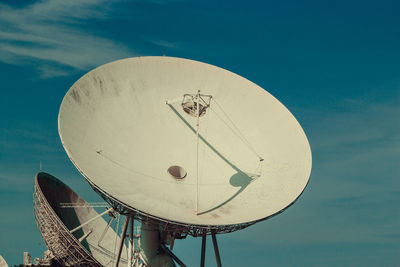 Low angle view of communications tower against sky