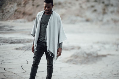 Full length of young man standing at beach