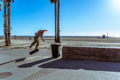 Man with umbrella against clear sky