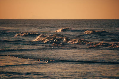 Scenic view of sea against clear sky during sunset