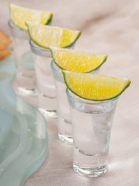 Drink glasses with lemons arranged on table