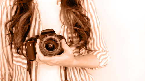 Rear view of woman photographing with camera