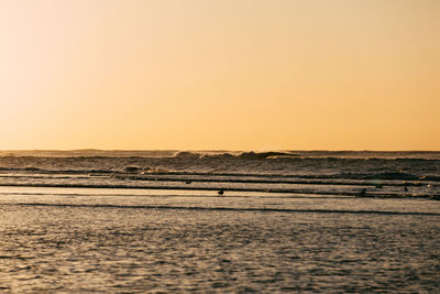 Scenic view of sea against clear sky during sunset