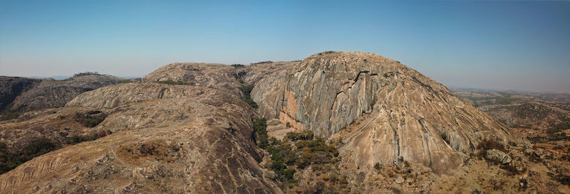 Panoramic view of rock formations on landscape against clear sky