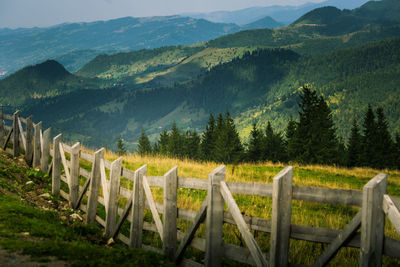 Scenic view of field and mountains against sky