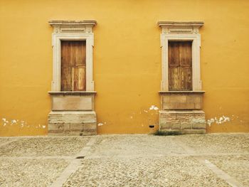 Exterior of yellow house by footpath