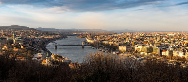 High angle view of river amidst buildings in city against sky