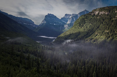 Scenic view of valley and mountains against sky