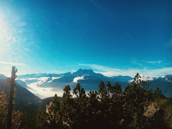 Scenic view of mountains against blue sky