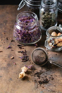 Close-up of various flowers in jar on table