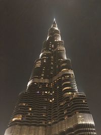 Low angle view of illuminated building against sky at night