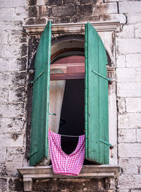 Low angle view of laundry drying on window