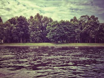 Scenic view of lake against cloudy sky