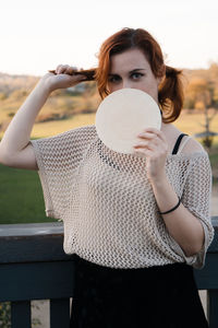 Portrait of woman standing against the wall