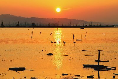 Scenic view of lake against sky during sunset