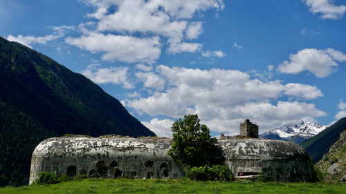 Built structure on field against sky