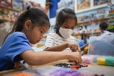 Children playing with toy on table