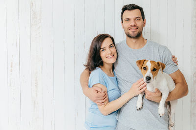 Portrait of smiling young woman with dog
