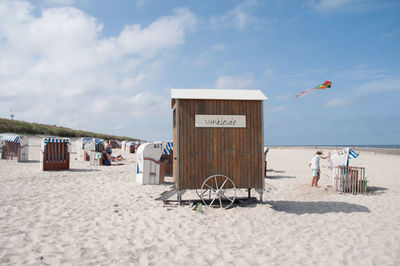 People and hut at beach