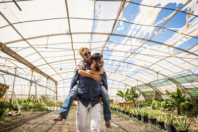 Young couple standing in greenhouse