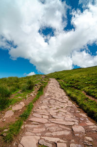 Dirt road along countryside landscape