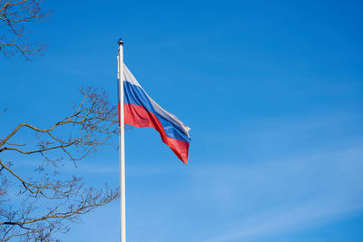 The flag of russia against the blue sky.