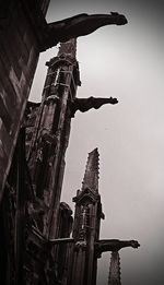 Low angle view of crane against sky