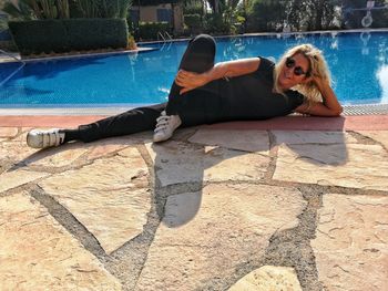 Young woman lying on swimming pool