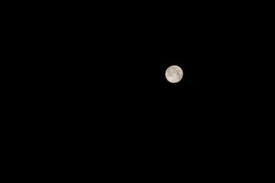 Low angle view of moon against clear sky at night