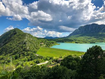 Scenic view of lake and mountains against sky