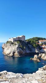 Scenic view of sea against clear blue sky