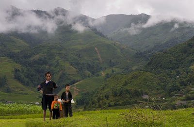 People on landscape against mountains