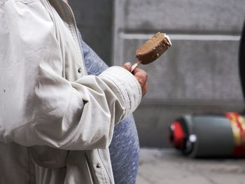 Midsection of man holding ice cream