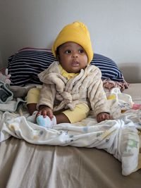 Cute baby boy sleeping on bed at home