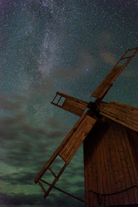 Low angle view of windmill against sky at night