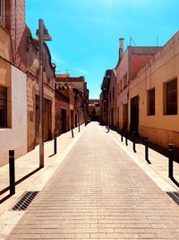 Empty alley amidst buildings in town