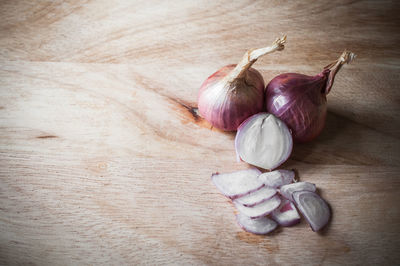 High angle view of onion on wooden table