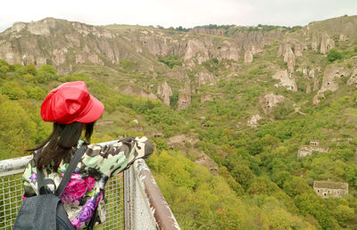 Female traveler visiting the historic cave settlement of old khndzoresk, armenia