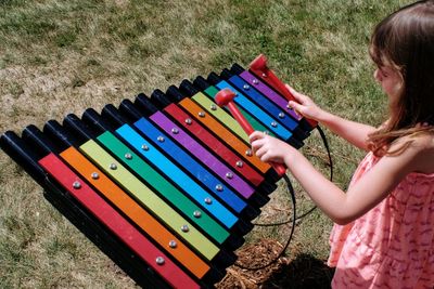 High angle view of girl with multi colored umbrella