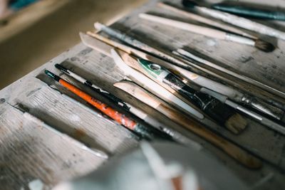 High angle view of old paintbrushes on table