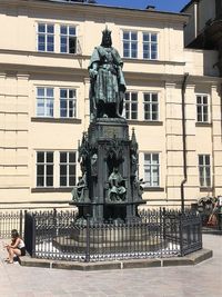 Statue against building in city