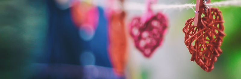 Close-up of multi colored flags hanging against wall