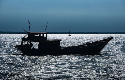 Boat moored in sea against sky