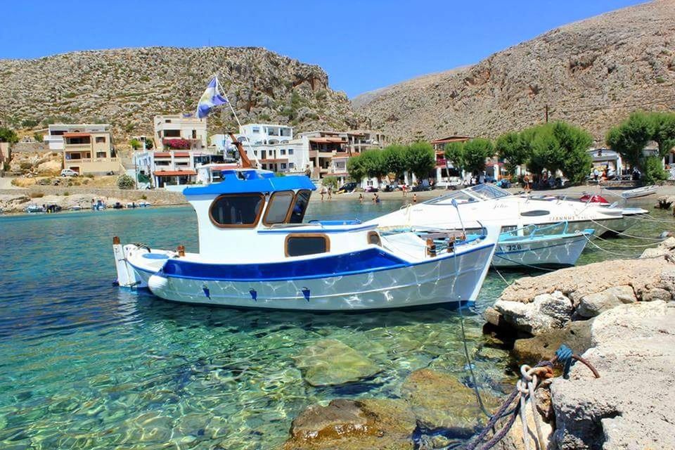 water, nautical vessel, transportation, mode of transportation, nature, moored, day, architecture, sunlight, sea, waterfront, sky, built structure, building exterior, blue, mountain, tree, no people, outdoors, yacht