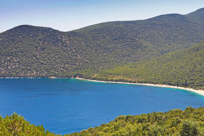 Scenic view of sea and mountains against sky