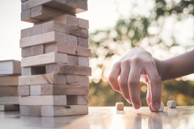 Hand of person playing jenga