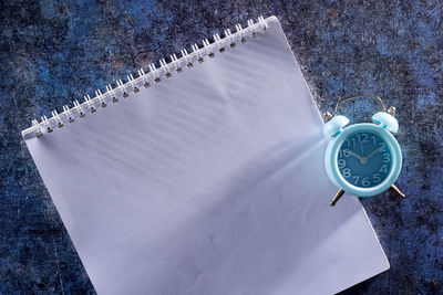 High angle view of clock on table