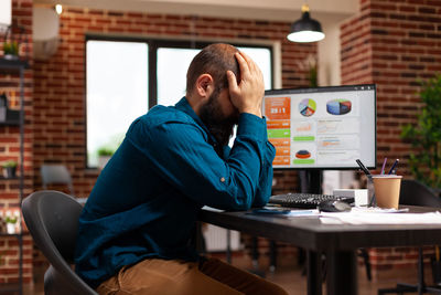 Side view of depression man siting in office