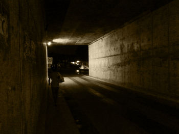 Illuminated tunnel at night